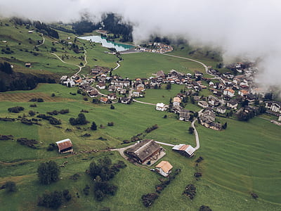 aerial photography of houses near mountain covered with smoke at daytime thumbnail