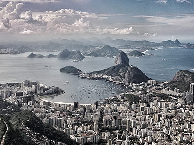aerial photography of city next to the sea thumbnail