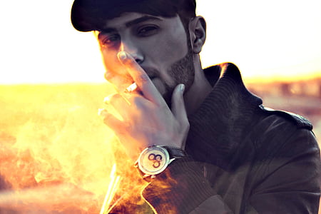 man wearing jacket while smoking cigarette thumbnail