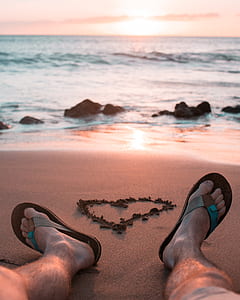 man lying on gray sand during daytime thumbnail