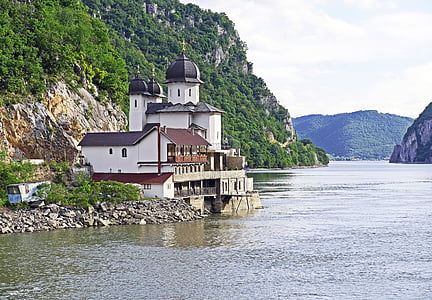 white building near body of water thumbnail