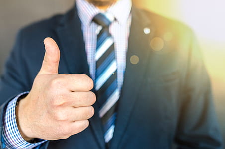 Close-up Photo of Man Wearing Black Suit Jacket Doing Thumbs Up Gesture thumbnail