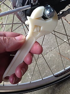 person turning bolt on bicycle using adjustable wrench thumbnail