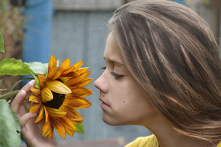 girl holding sunflower thumbnail