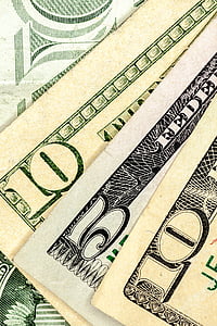 closeup photo of two 10 and one 5 U.S. dollar banknotes thumbnail