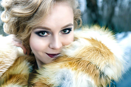 closeup photography of woman wearing white and brown fur tops thumbnail