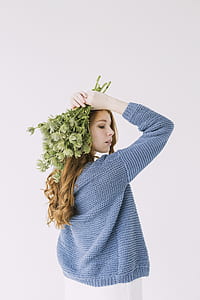 Woman in Blue Knit Cable Sweater Holding Green Petaled Flowers thumbnail