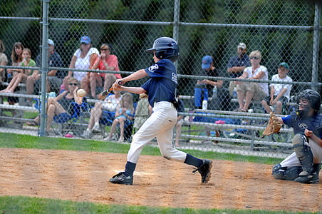 boy swinging bat on baseball game during daytime thumbnail