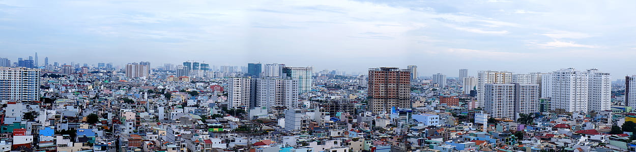 photo of city buildings under cloudy sky thumbnail