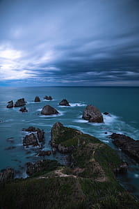 photography of body of water with islets thumbnail