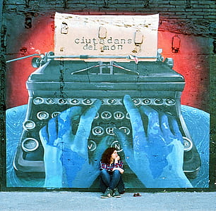 woman sitting on floor beside the typewriter graffiti thumbnail