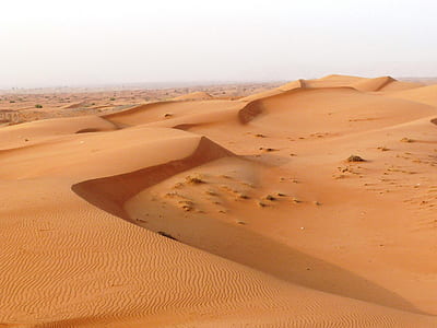 brown desert under bright sky thumbnail