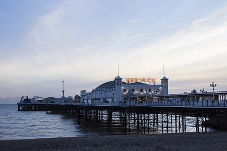 white building on dock near during daytime thumbnail