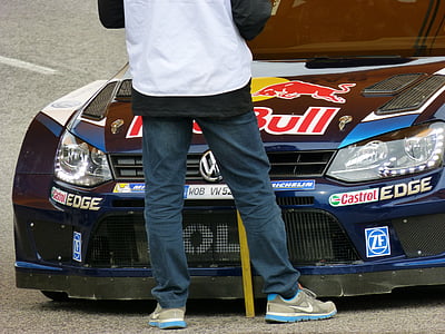 person standing in front of blue Volkswagen RedBull vehicle thumbnail
