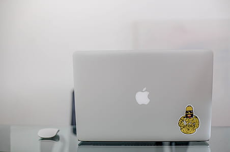 MacBook on glass desk thumbnail