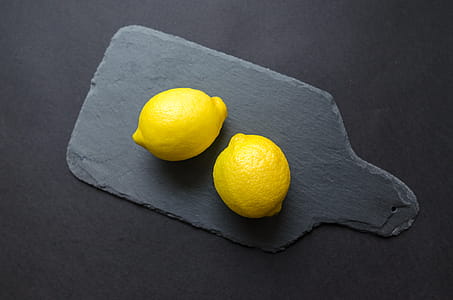 Two Lemons on Black Wooden Pad thumbnail