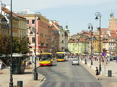 people walking beside buildings near buses thumbnail