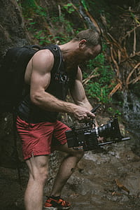 man carrying backpack taking a video thumbnail