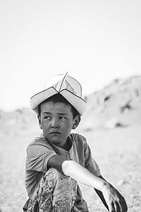 boy in zip-up shirt and white hat thumbnail