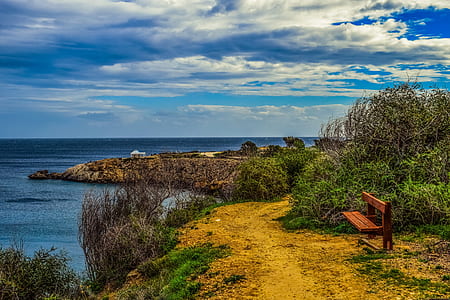 photography of bench on mountain near cliff thumbnail