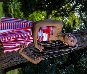 woman holding her braided hair thumbnail