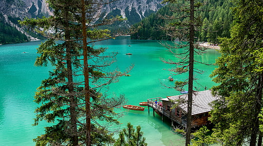 body of water near brown house thumbnail