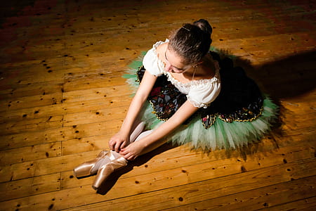 woman sitting on brown wooden floor thumbnail