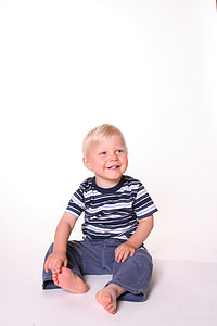 boy sitting on floor beside wall thumbnail