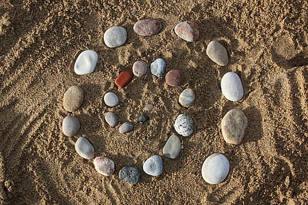 swirl stone arrangement on brown sand thumbnail