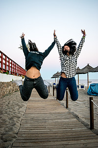 two woman jumping off dock thumbnail
