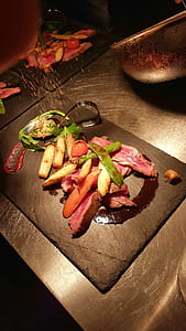 sliced steak, potatoes, and peas on brown wooden chopping board thumbnail