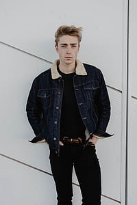 man standing beside wall thumbnail