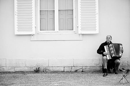 grayscale photography of person playing musical instrument thumbnail