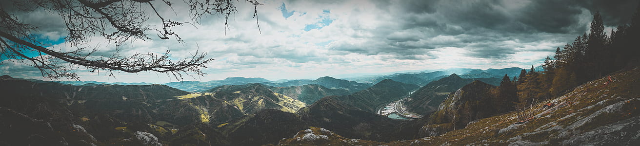 panoramic photography of mountain under cloudy sky thumbnail