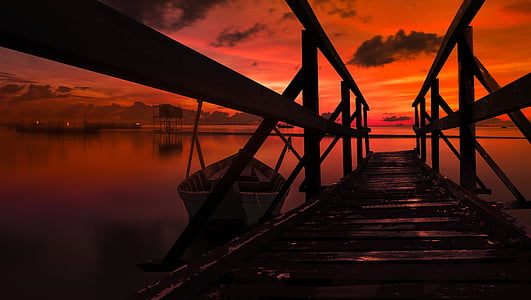 twilight hour on dock under cloudy sky thumbnail
