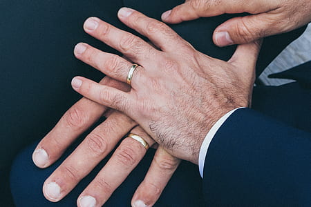 two persons wearing gold-colored rings thumbnail