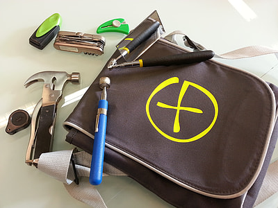 assorted miniature hammer, grinder, and Swiss knife with brown bag thumbnail