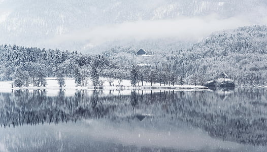 body of water near snow covered mountain thumbnail