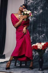 Woman in Red Dress Holding Flower thumbnail
