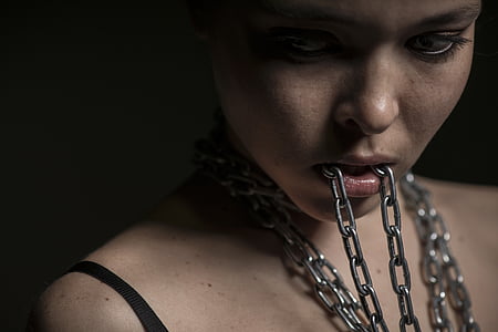 woman biting gray chain thumbnail