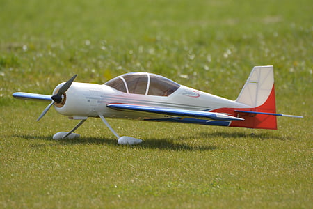 white and red airplane toy on grass thumbnail