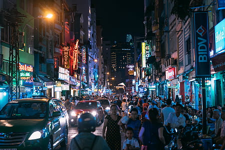 people walking on the street near cars thumbnail