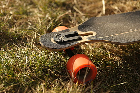 black and orange longboard on brown grass thumbnail
