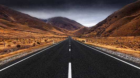 gray empty road under nimbus clouds thumbnail