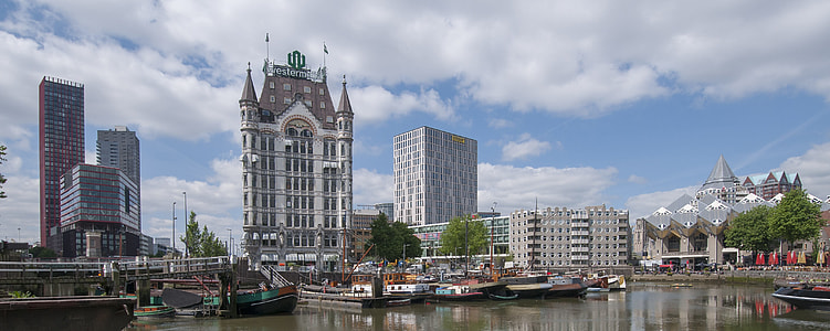 white and gray concrete high-rise building near body of water photo thumbnail