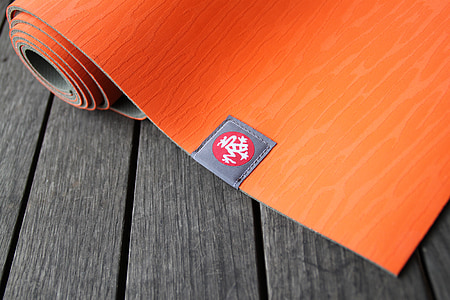 red yoga mat placed on gray board thumbnail