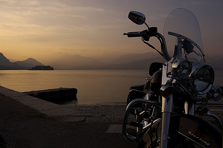 black cruiser motorcycle parked near seashore thumbnail