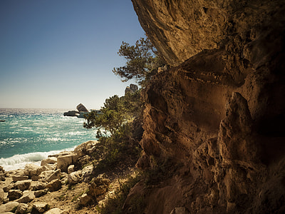 brown rock formation near beach at daytime thumbnail