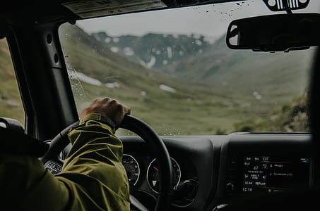 person in green long-sleeved top driving thumbnail