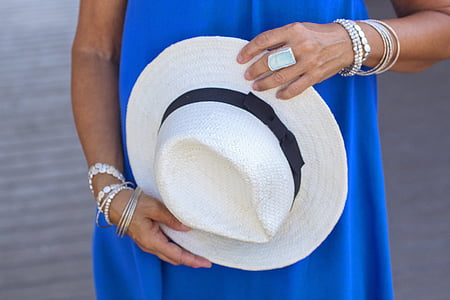 person holding white fedora hat thumbnail
